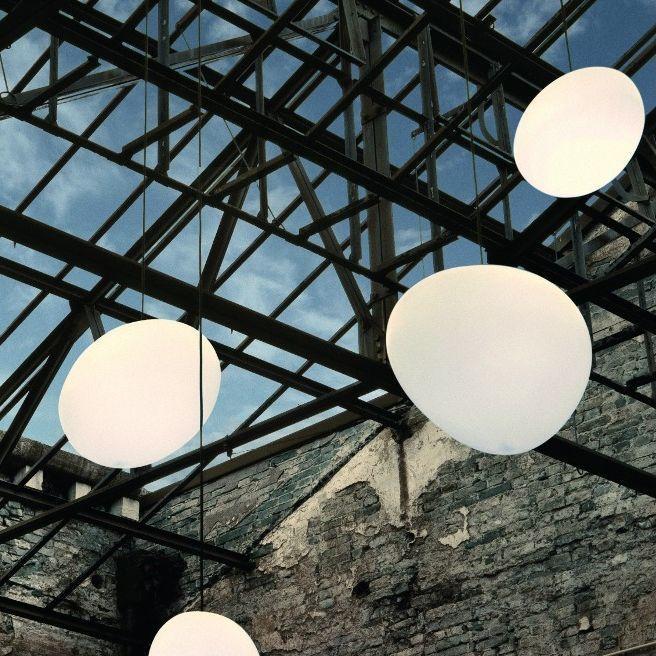 From left: Glo-Ball Suspension from Flos, designed by Jasper Morrison; a cluster of ​​Gregg Suspension Lights from Foscarini, designed by Ludovica & Roberto Palomba