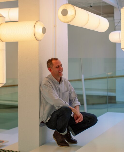 Designer Anthony Dickens with his Tekiò designs hanging overhead