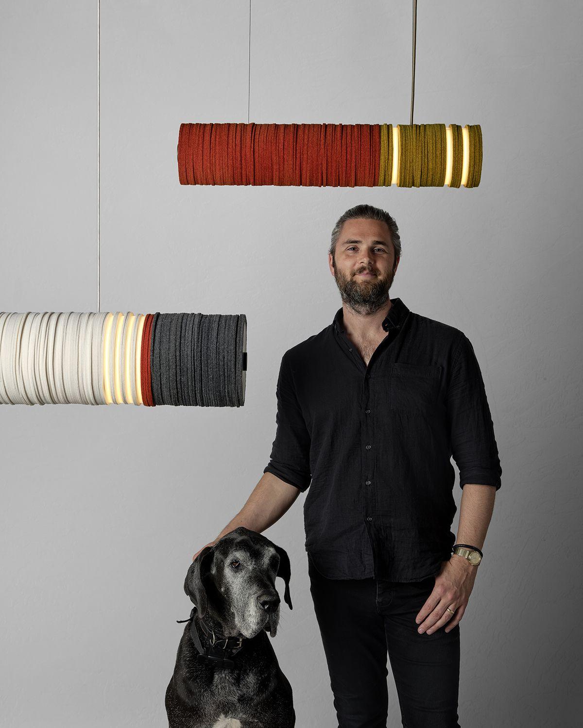 Jeff Forrest with a canine friend posing in front of STACKABL lights