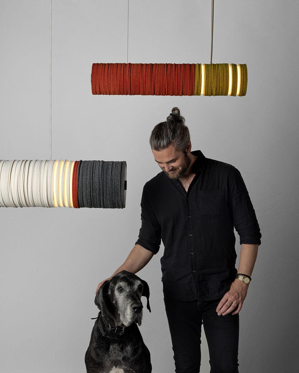 Jeff Forrest with a canine friend posing in front of STACKABL lights