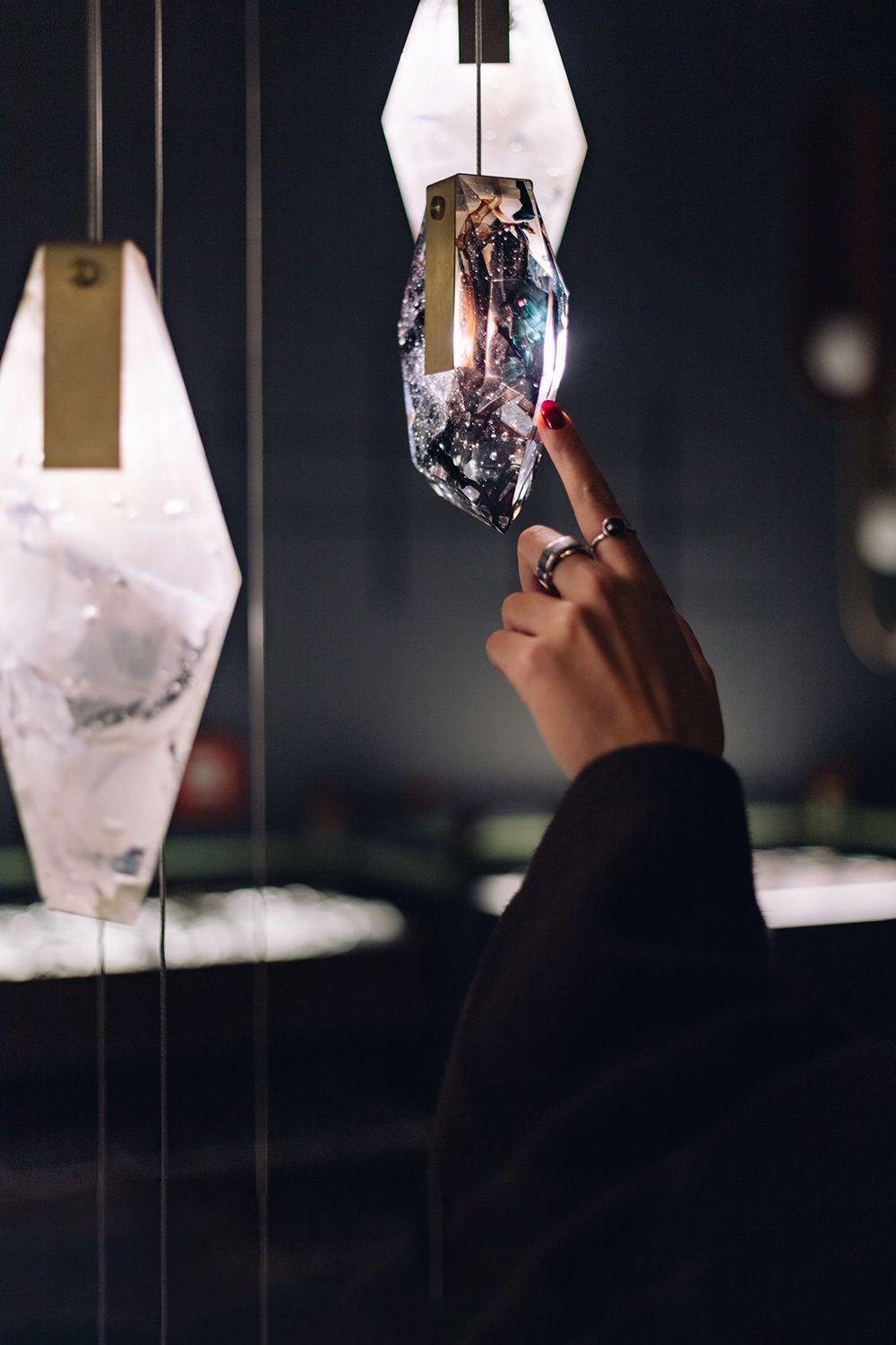 Clusters of the Fragments Collection, featuring metal accents, being adored by onlookers