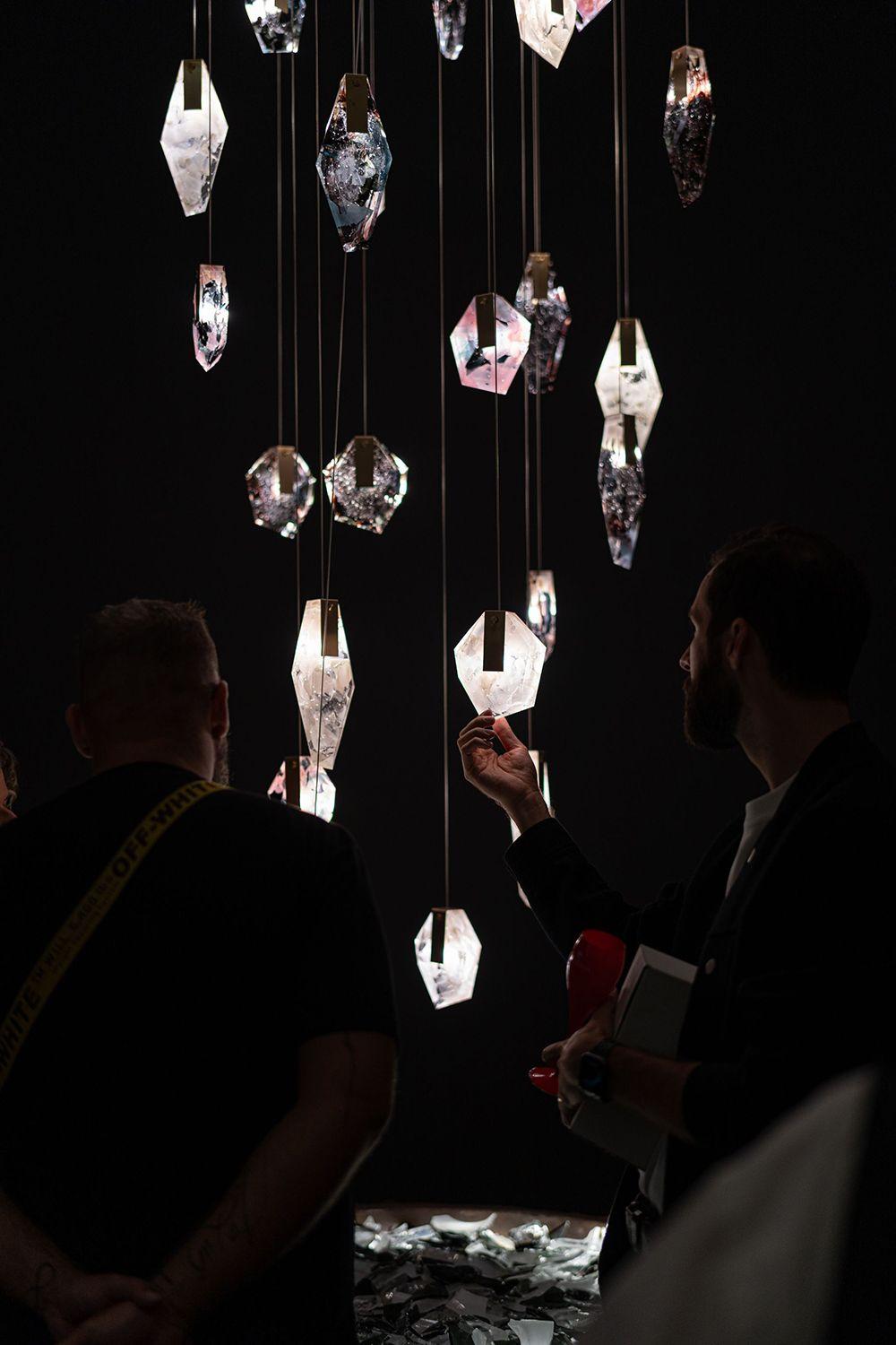Clusters of the Fragments Collection, featuring metal accents, being adored by onlookers