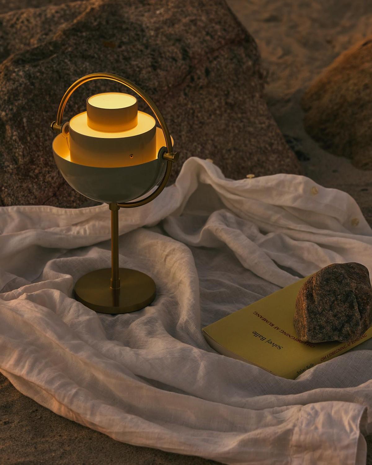 The Multi-Lite Portable Lamp from Gubi features an adjustable shade, so you can direct the light up or down, depending on your mood, whether you’re indoors or out.