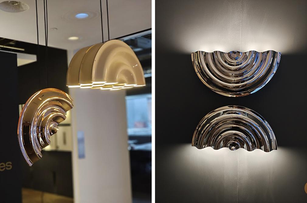 Doppler Pendant Suspension in 12K Gold hanging next to the Triple Suspension in Glossy Ivory (left), and the Doppler Wall Lights facing up and down, on display at LightForm Toronto