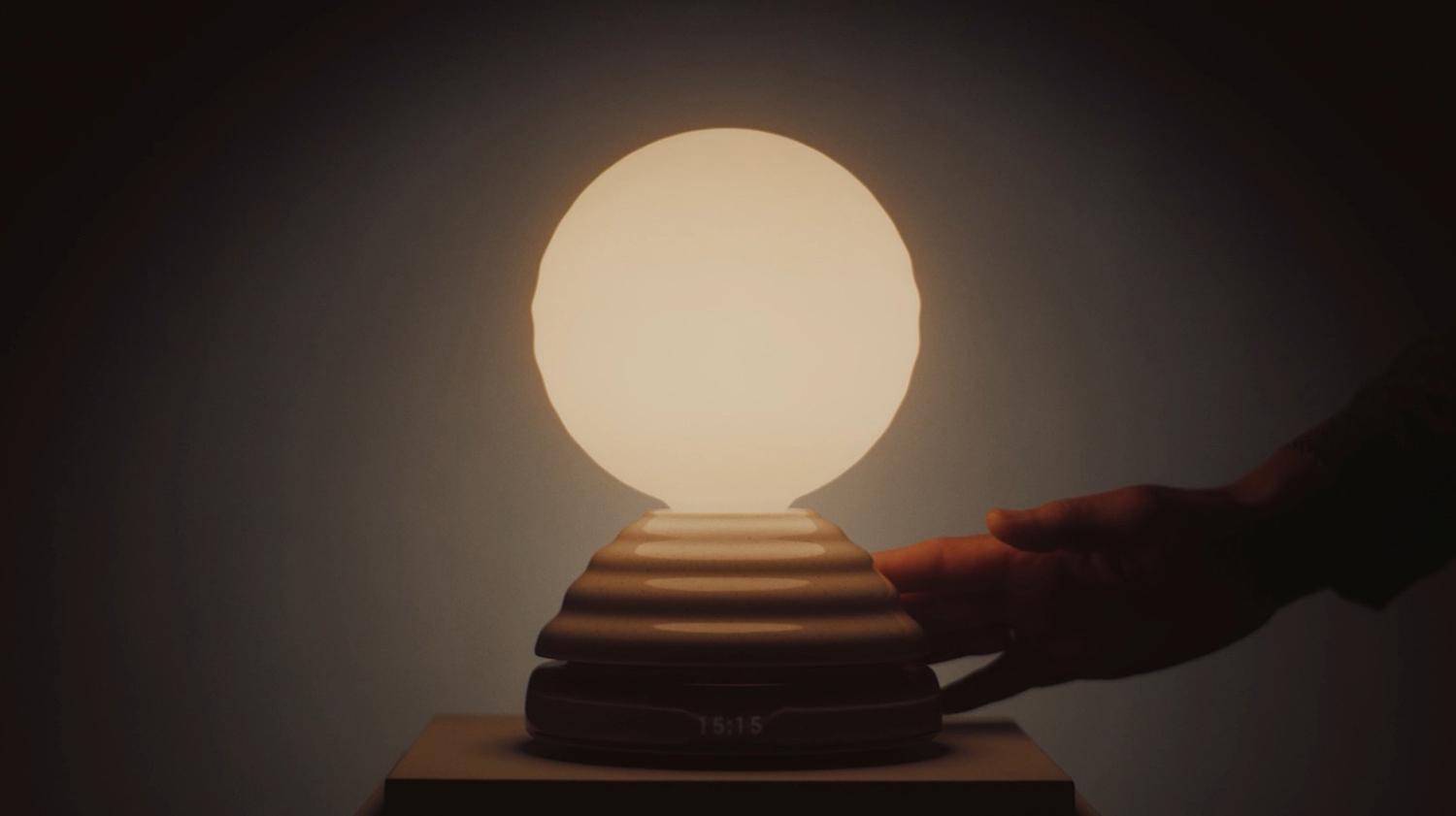 A serene and minimalist living space illuminated by the Cesta Metallica Table Lamp (left) and Babel Table Lamp (right) from Santa & Cole.