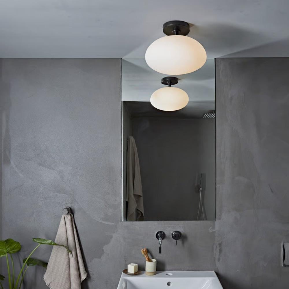 Zeppo Ceiling Light (left) is damp-rated, ideal for bathroom use around the sink or toilet; Vancouver Round LED (right) is wet-rated, perfect for above the shower or outdoors.