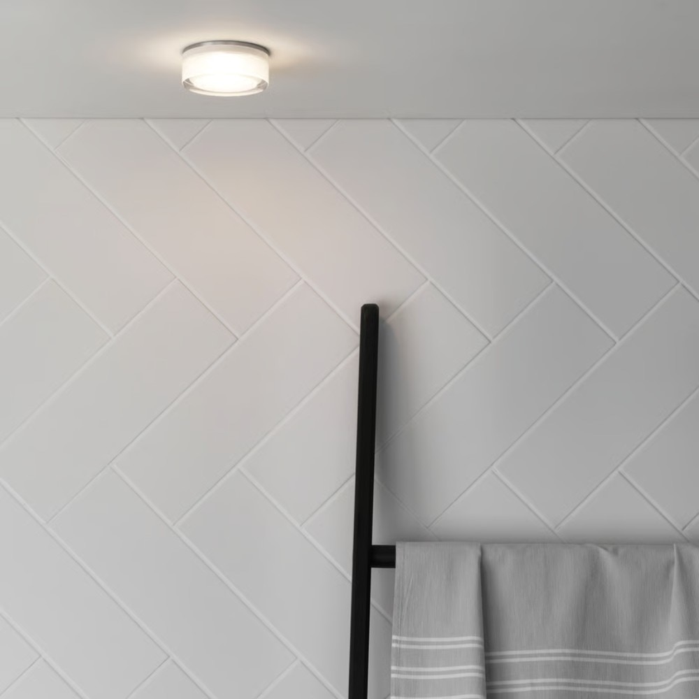 Zeppo Ceiling Light (left) is damp-rated, ideal for bathroom use around the sink or toilet; Vancouver Round LED (right) is wet-rated, perfect for above the shower or outdoors.